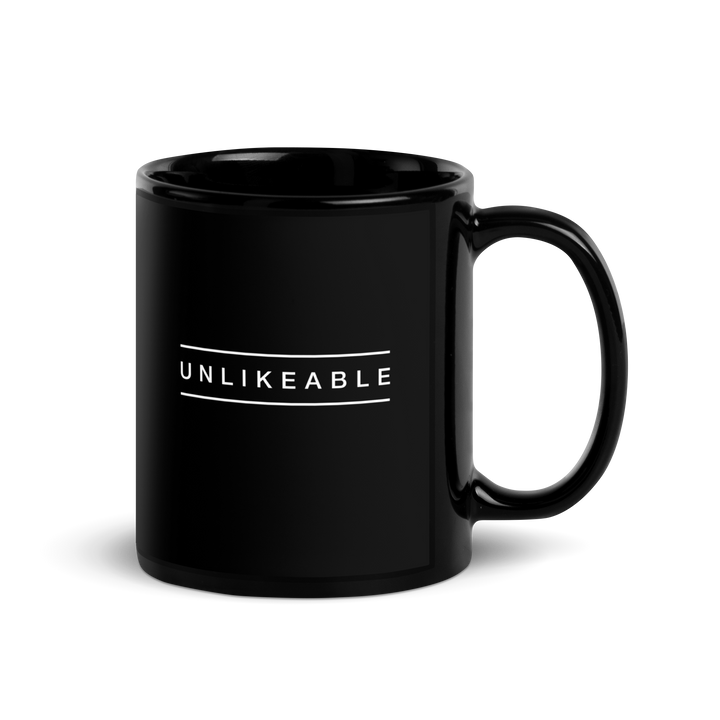 black glossy mug with the word unlikeable in white.